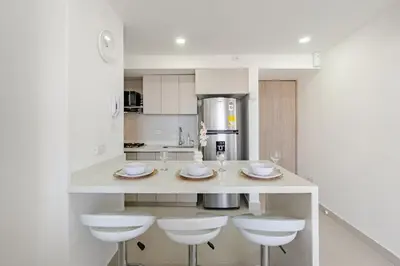 a kitchen with a counter with three stools and a counter top at Very close to the beach and the historic center in Cartagena de Indias