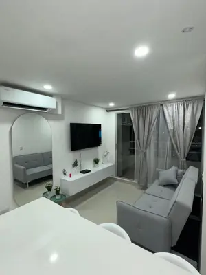 a living room with a couch and a flat screen tv at Very close to the beach and the historic center in Cartagena de Indias