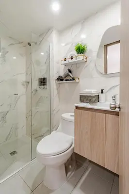 a bathroom with a toilet and a glass shower at Very close to the beach and the historic center in Cartagena de Indias