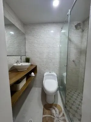 a bathroom with a toilet and a sink and a shower at Palo Rosa Caribe 202 in Coveñas