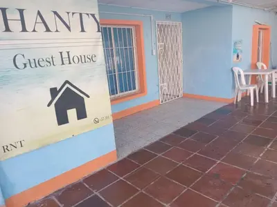 a guest house with a guest house sign on a wall at shanty guest hostal in Cartagena de Indias