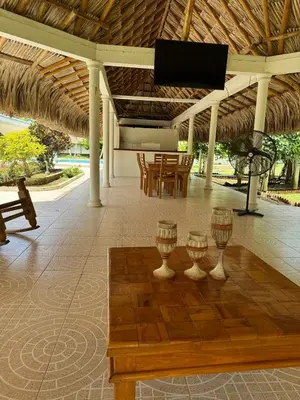 a porch with two wine glasses on a wooden floor at Cabaña la fortuna in Turbaco
