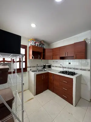 a kitchen with a sink and a stove in it at Cabaña la fortuna in Turbaco