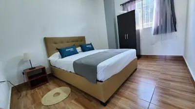 a bedroom with a large bed with blue pillows at Suite hm caribe in Santa Marta