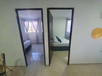 two mirrors in a room with a bed and a bedroom at Suite hm caribe in Santa Marta