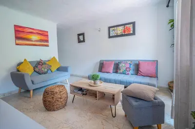 a living room with two blue couches and a table at San Diego Acogedor Duplex cerca a Bóvedas in Cartagena de Indias