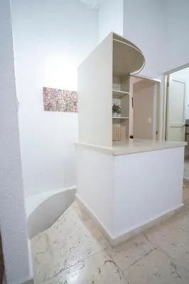 a kitchen with white walls and a white counter at San Diego Acogedor Duplex cerca a Bóvedas in Cartagena de Indias