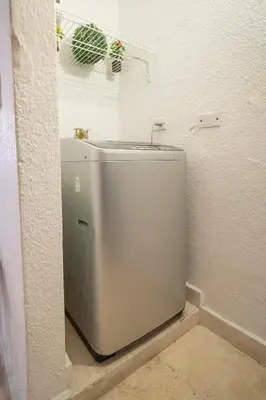 a white toilet in a corner of a bathroom at San Diego Acogedor Duplex cerca a Bóvedas in Cartagena de Indias