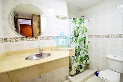 a bathroom with a sink and a mirror and a toilet at Estudio piso 6 in Cartagena de Indias