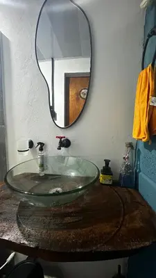 a bathroom with a glass sink and a mirror at Cabaña Coveñas Tolú in Coveñas