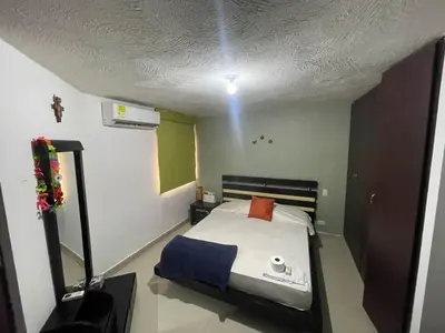 a bedroom with a bed and a light on the ceiling at APARTAMENTO-Miramar in Barranquilla