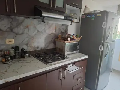 a kitchen with a stove and a refrigerator at APARTAMENTO-Miramar in Barranquilla