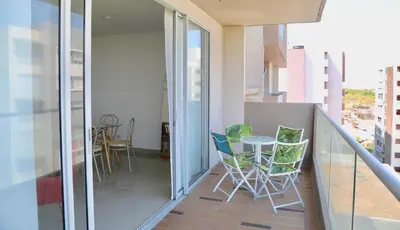 a balcony with chairs and a table on it at Apartamento en Riomar in Barranquilla