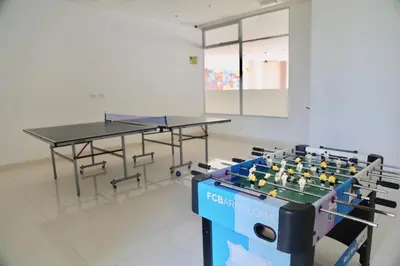 a room with two ping pong tables and chairs at Apartamento en Riomar in Barranquilla