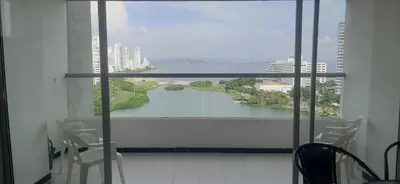 a room with a large window with a view of a river at Apartamento Tres Carabelas El Laguito in Cartagena de Indias