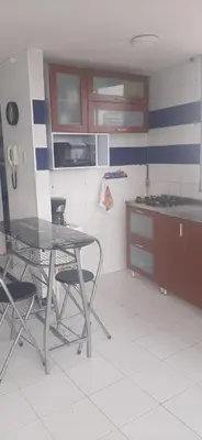 a kitchen with a table and chairs in it at Apartamento Tres Carabelas El Laguito in Cartagena de Indias