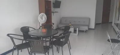 a dining room with a glass table and chairs at Apartamento Tres Carabelas El Laguito in Cartagena de Indias