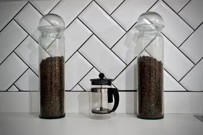 two glass containers filled with seeds and a coffee pot at Villa frente el mar cartagena de indias in Cartagena de Indias