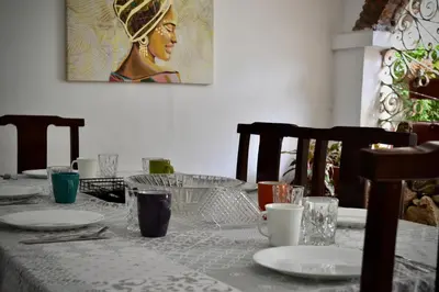 a table with plates and glasses on top of it at Villa frente el mar cartagena de indias in Cartagena de Indias