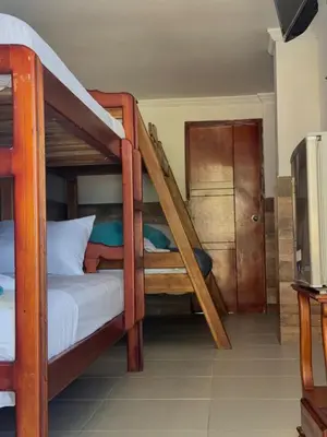 a bedroom with two bunk beds and a door at Apartamento frente al mar orilla beach house in Playa Punta Arena