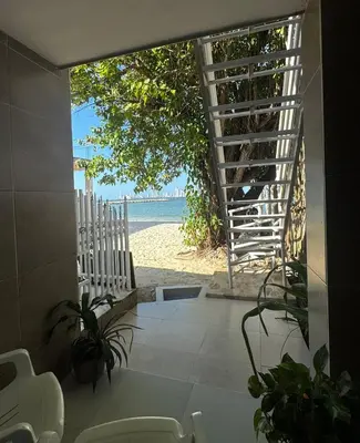 a view of the beach from a house with a staircase at Apartamento frente al mar orilla beach house in Playa Punta Arena