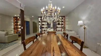 a dining room with a long table and a chandelier at Hotel Casa La Tablada Aeropuerto in Cartagena de Indias