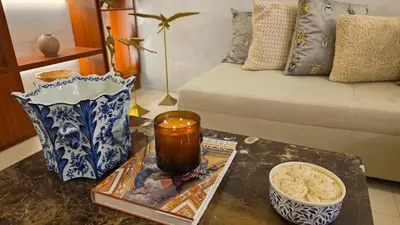 a living room with a table with a candle and a couch at Hotel Casa La Tablada Aeropuerto in Cartagena de Indias