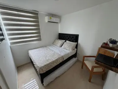 a small bedroom with a bed and a window at Conjunto Residencial Caribe Campestre in Coveñas