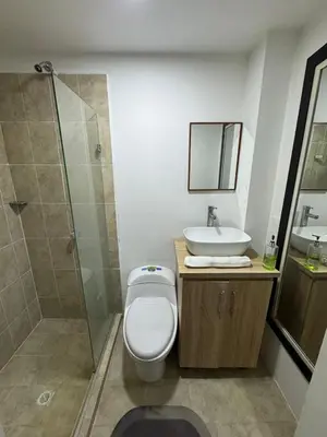 a bathroom with a toilet and a sink and a shower at Conjunto Residencial Caribe Campestre in Coveñas