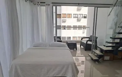 a bedroom with a bed and a view of a building at Dúplex en Bocagrande Cartagena Piscina, jacuzzi y a 2 cuadras del mar in Cartagena de Indias