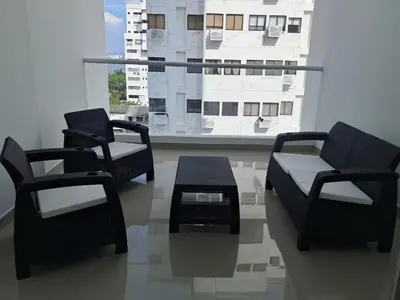 three chairs and a table in a room with a window at Dúplex en Bocagrande Cartagena Piscina, jacuzzi y a 2 cuadras del mar in Cartagena de Indias