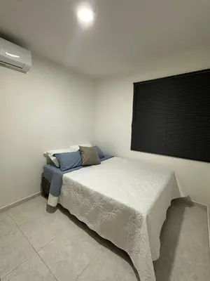 a bedroom with a bed in a room with a window at Entrelagos beautiful apartment in Cartagena de Indias