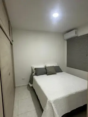 a bedroom with a white bed in a room at Entrelagos beautiful apartment in Cartagena de Indias