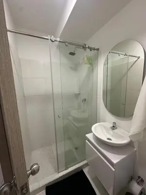 a bathroom with a glass shower and a sink at Entrelagos beautiful apartment in Cartagena de Indias