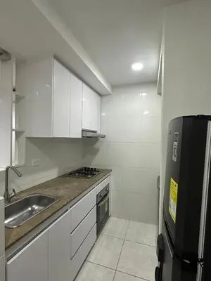 a small kitchen with a sink and a refrigerator at Entrelagos beautiful apartment in Cartagena de Indias