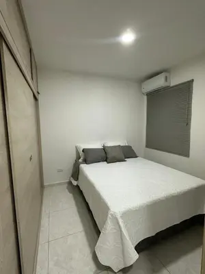 a bedroom with a bed in a white room at Entrelagos beautiful apartment in Cartagena de Indias