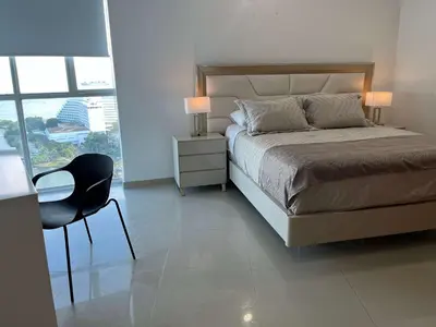 a bedroom with a bed and a desk and a chair at New apartment with a beautiful view 2002 in Cartagena de Indias
