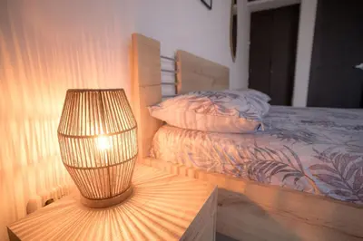 a lamp sitting on a table next to a bed at Stunning Caribbean-Inspired PH next to Viva Mall in Barranquilla
