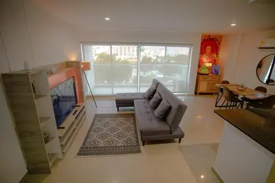 a living room with a couch and a television at Stunning Caribbean-Inspired PH next to Viva Mall in Barranquilla
