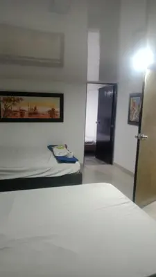 a bedroom with a bed and a door to a room at cabaña frente al mar de cartagena in Cartagena de Indias