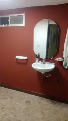 a bathroom with a white sink and a mirror at cabaña frente al mar de cartagena in Cartagena de Indias