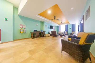 a waiting room with chairs and tables in a room at Hotel El Viajero #2 in Cartagena de Indias