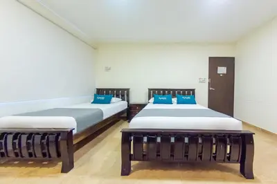 two beds in a room with blue pillows at Hotel El Viajero #2 in Cartagena de Indias