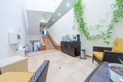 a living room with a table and chairs and a staircase at Hotel El Viajero #2 in Cartagena de Indias