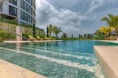 a swimming pool with chairs and a building at Bohemian 2BR - Morros Kai - Private pool & parking in Cartagena de Indias