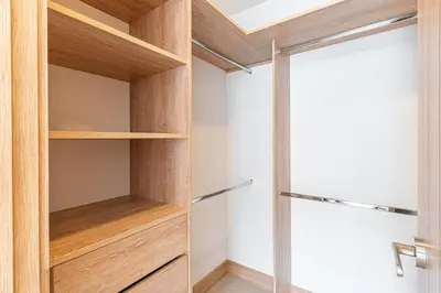 a walk in closet with wooden shelves and a glass door at Bohemian 2BR - Morros Kai - Private pool & parking in Cartagena de Indias