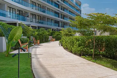 a sidewalk in front of a building with benches at Bohemian 2BR - Morros Kai - Private pool & parking in Cartagena de Indias