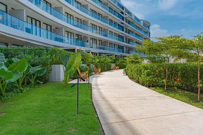 a sidewalk with benches in front of a building at Bohemian 2BR - Morros Kai - Private pool & parking in Cartagena de Indias