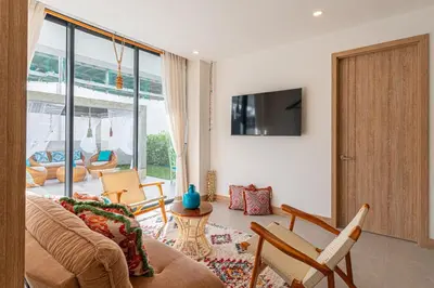 a living room with a couch and chairs and a tv at Bohemian 2BR - Morros Kai - Private pool & parking in Cartagena de Indias