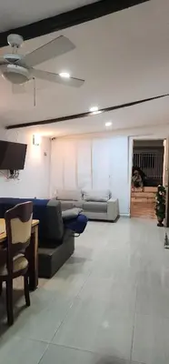 a living room with a couch and a table at Casa de Playa Salgar in Puerto Colombia